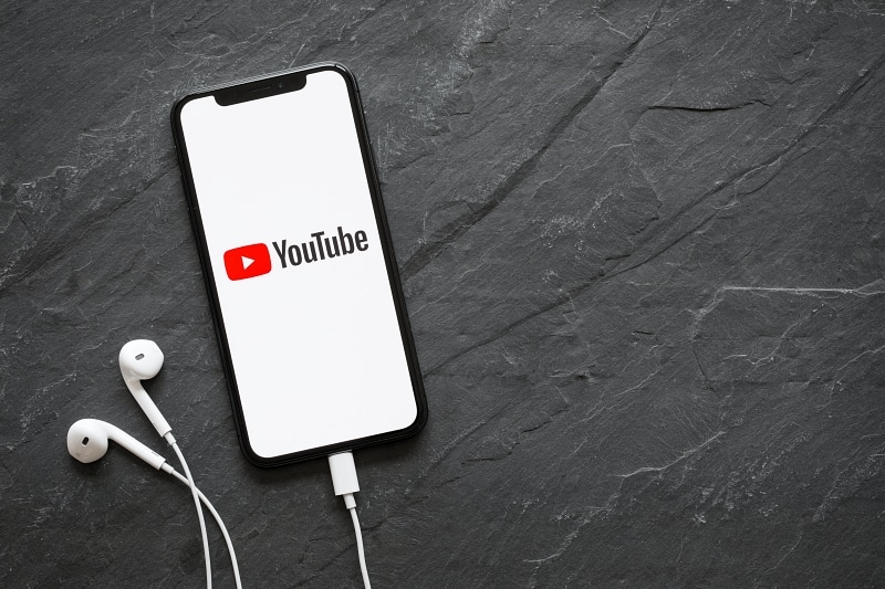 Youtube displayed on phone with headphones attached