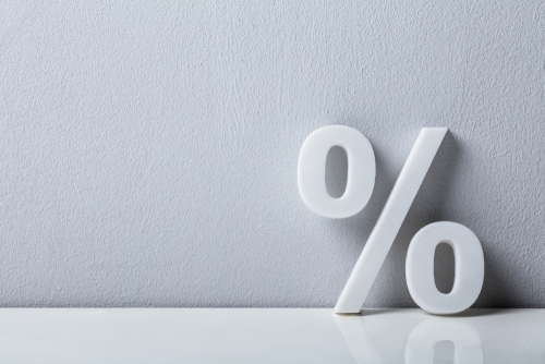 Image of percent sign leaning on a wall in 3d