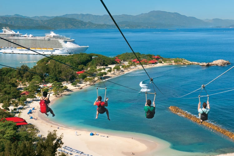 friends zip line skiing into the sea